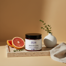 Load image into Gallery viewer, Thyme & Grapefruit Whipped Shea Butter styled on stone tray with grapefruit and thyme by Jilyn Skincare