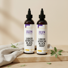 Load image into Gallery viewer, Two Jilyn Skincare Liquid African Black Soap 8oz bottles styled with linen and botanicals on warm stone surface